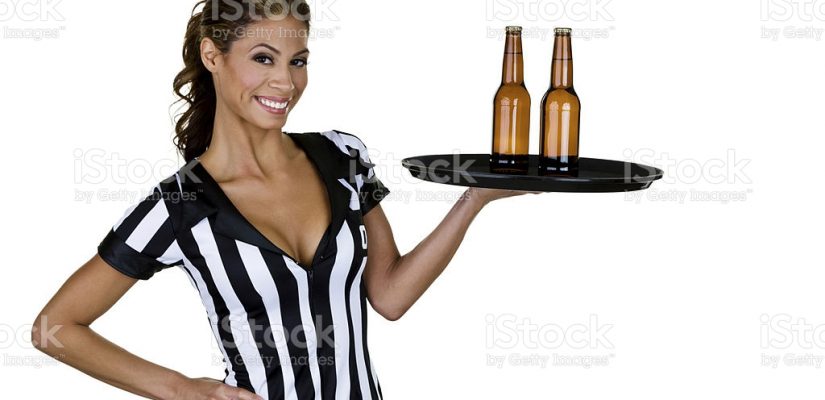 Cute woman wearing a sexy referee outfit and holding a tray of beer for a sports bar concept